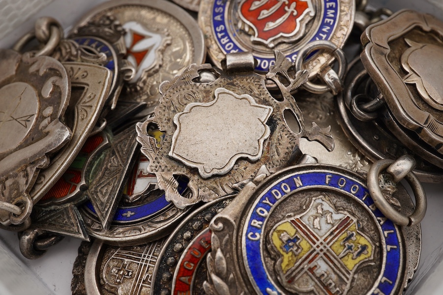 A group of twenty one assorted early 20th century silver and enamel award medals, mostly sporting. Condition - poor to fair